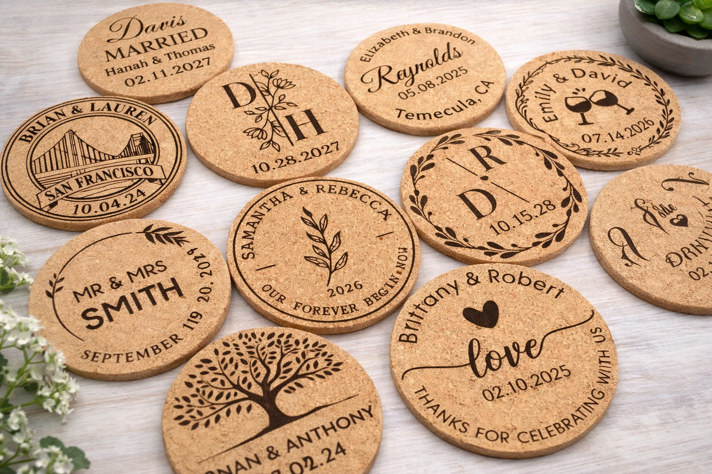 Personalized cork coasters with engraved designs and text on a light wooden surface.