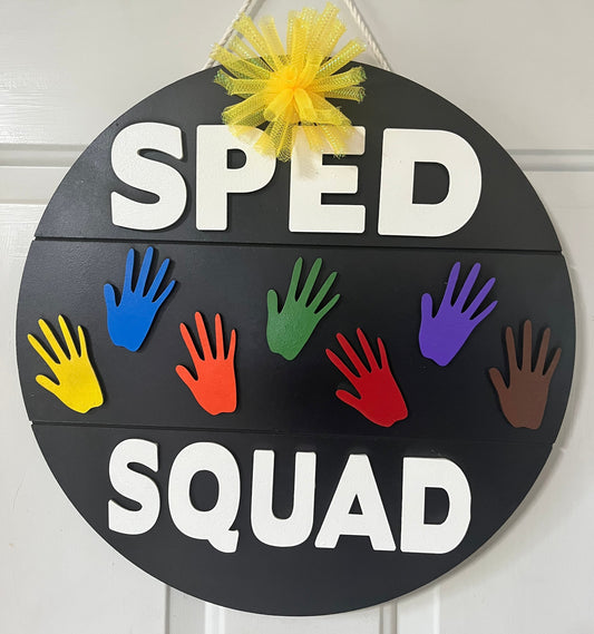 SPED Squad finished painted sign with rainbow hands on classroom door
