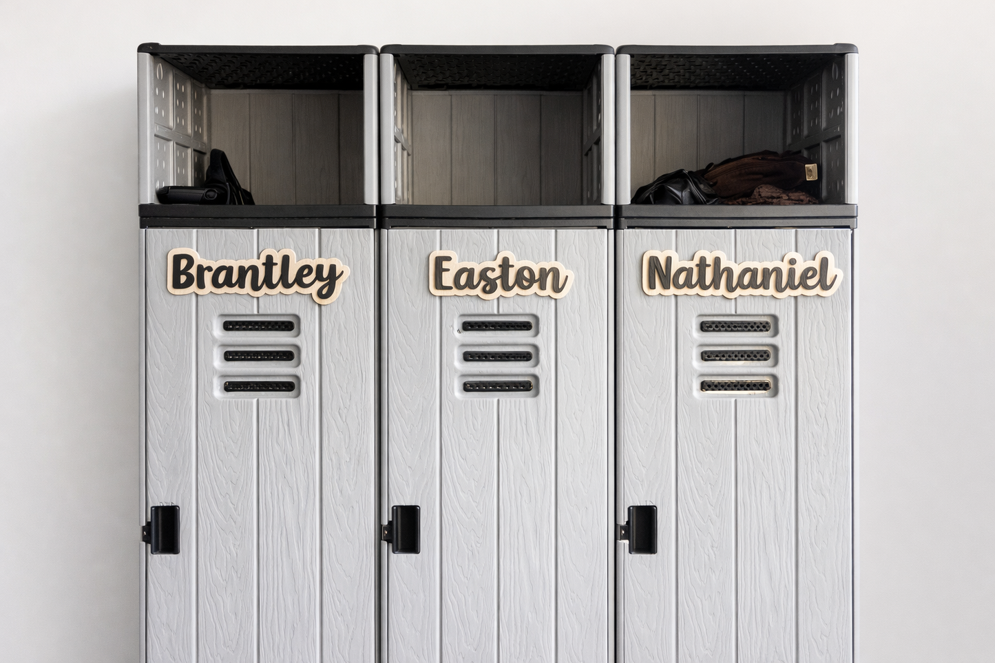 Three white lockers with personalized names on a light gray background