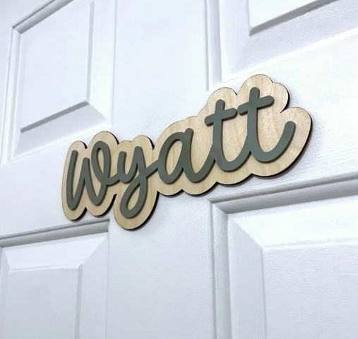 Wooden nameplate with 'wyatt' on a white door