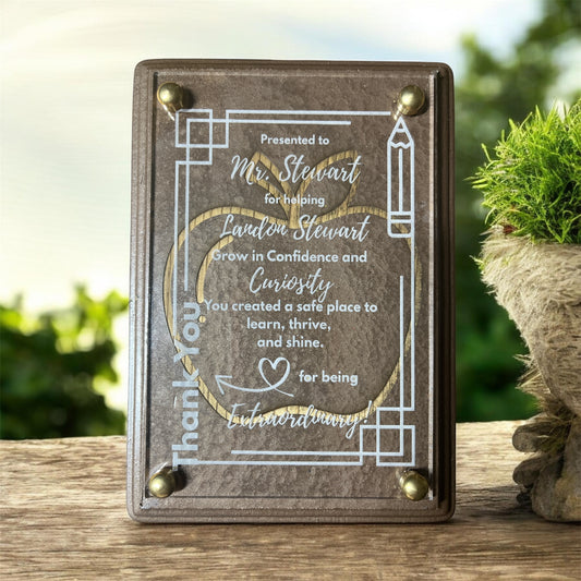 Wooden plaque with engraved text on a wooden surface with a blurred natural background