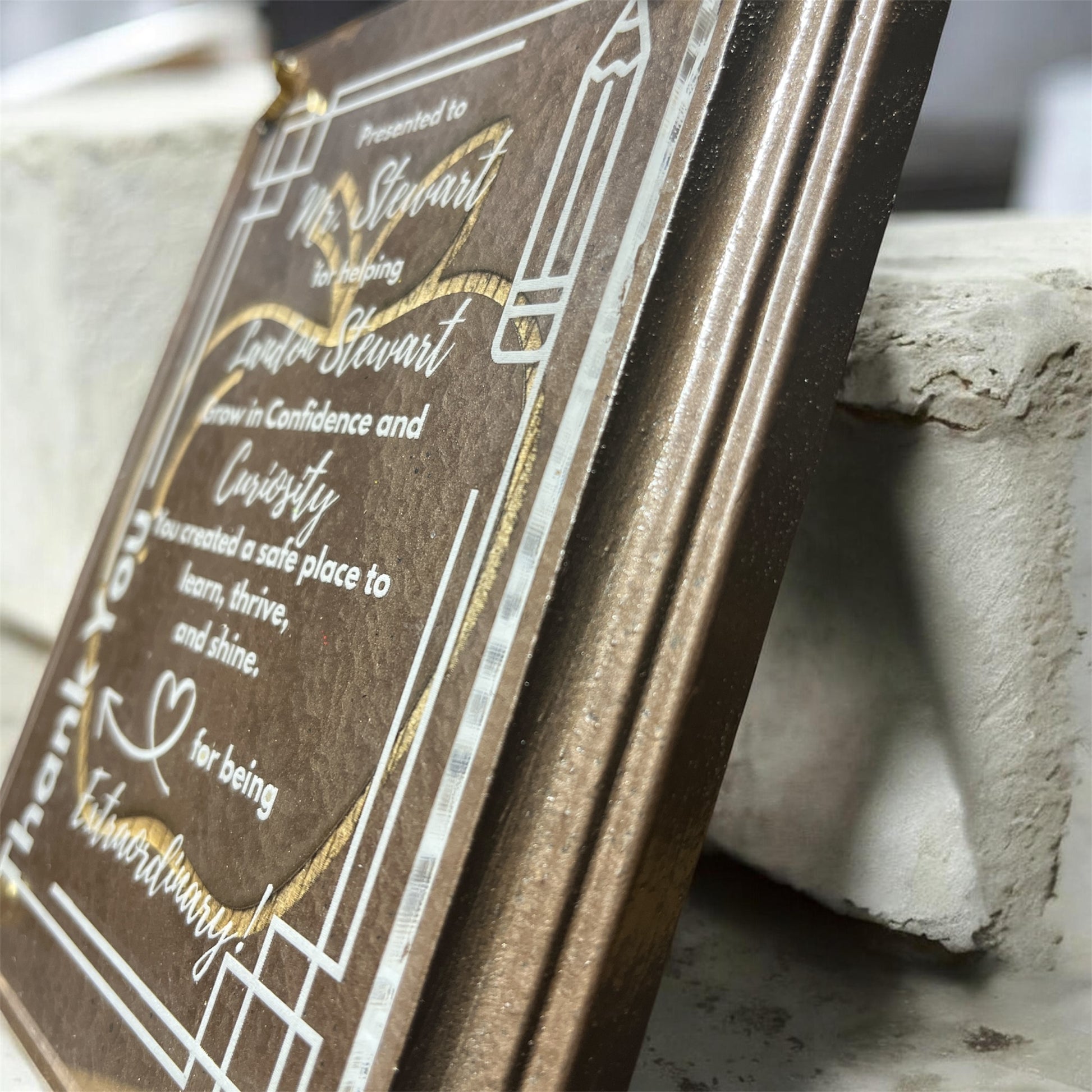 Decorative plaque with engraved text on a stone surface