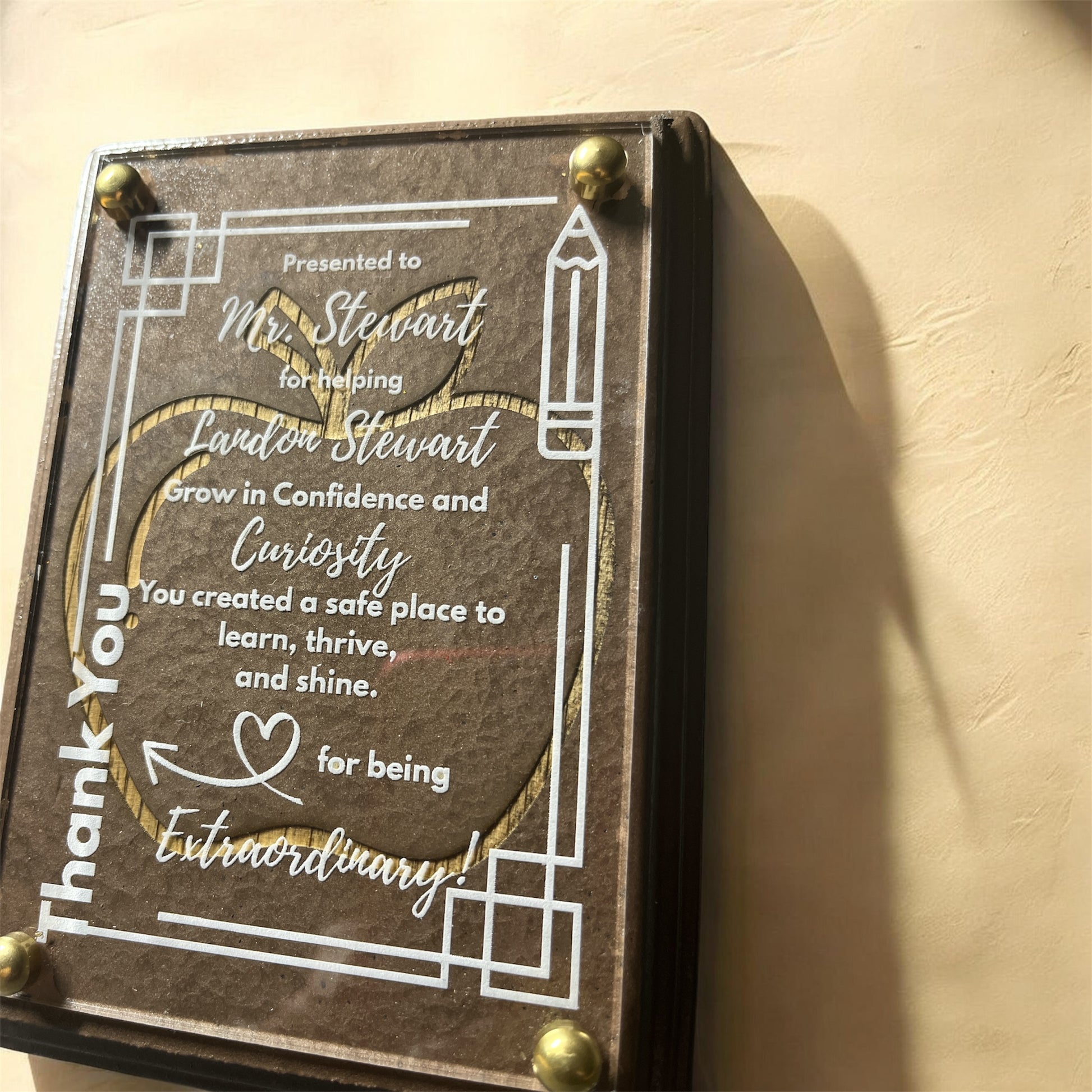 Decorative plaque with engraved text on a beige background