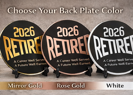 Three '2026 Retired' back plates in mirror gold, rose gold, and white on stands.